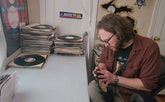 Michael hand trimming the records for customer